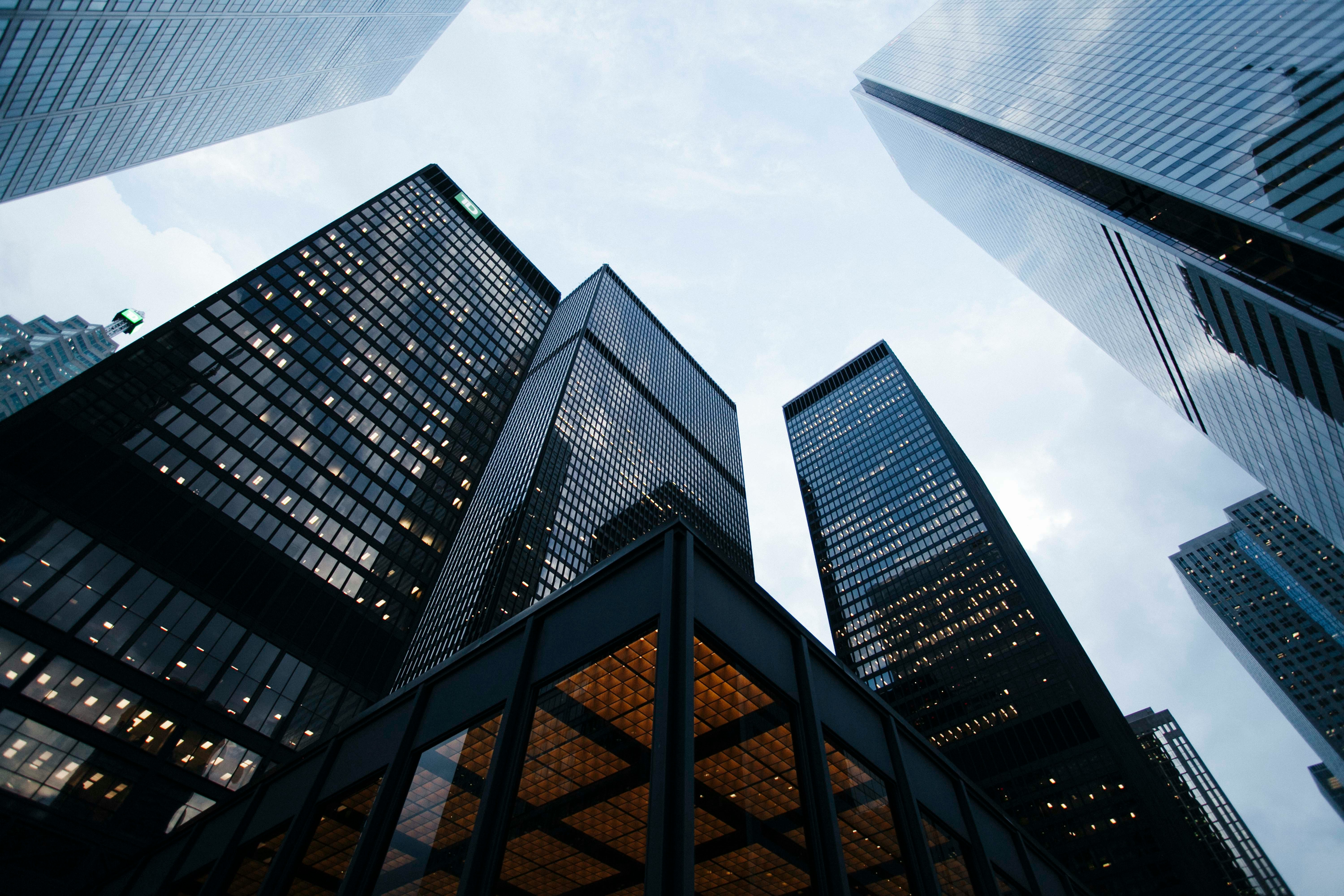 Glass office towers viewed from street level.